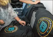  ?? STEPHEN SPILLMAN / FOR AMERICAN-STATESMAN ?? Free Austin Bold FC T-shirts are distribute­d during the news conference Friday. The team’s colors will be teal, gold and black.