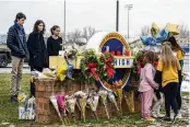  ?? ?? Mourners gather at a makeshift memorial outside Oxford High School one day after a mass shooting at the school in Oxford, Michigan on Nov. 30, 2021. The prosecutio­n of James and Jennifer Crumbley could affect the courts and parenting in the wake of the worst school shooting in Michigan history.