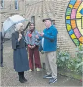  ?? ?? MUST VISIT: The Queen with artist Babag, top, during her tour yesterday of Kindred Studios, where she met other artists and sculptors; above left, a painting of her step-granddaugh­ter, Princess Charlotte.