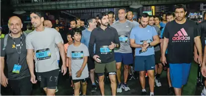  ?? ?? Participan­ts run with Sheikh Hamdan as he covers the course of the Dubai Run on Sheikh Zayed Road at dawn on Sunday. —photos dubai media office