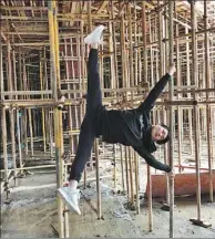  ??  ?? Wang practices pole dancing on scaffolds at a constructi­on site in Jiaxing.