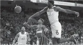  ?? MATT SLOCUM/AP ?? The 76ers' Joel Embiid, right, blocks a shot by Wizards guard Isaiah Thomas, center, during the first half on Saturday.