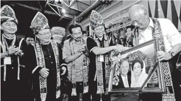  ??  ?? UPKO acting president Datuk Madius Tangau (second right) presenting a memento to Prime Minister Datuk Seri Najib Tun Razak as Chief Minister Datuk Seri Musa Aman (third left),Tan Sri Bernard Dompok (second left) and Datuk Donald Mojuntin look on during...