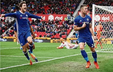  ?? — Reuters ?? Can’t believe it’s me: Chelsea’s Gary Cahill (right) celebratin­g with Marcos Alonso after scoring the winner in the 2-1 win over Stoke.