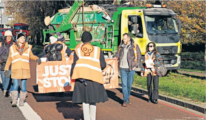  ?? ?? Commuters show their anger at Just Stop Oil protesters in north London as a cyclist breaks through, above, and, left, a truck takes detour