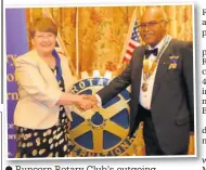  ??  ?? Runcorn Rotary Club’s outgoing President, Rosalind Gregory, welcomes her successor Tony Rudde