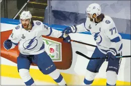  ?? JASON FRANSON — THE ASSOCIATED PRESS ?? Tampa Bay’s Brayden Point, left, celebrates his first-period goal against Dallas with Victor Hedman (77) during Game 6 of the Stanley Cup Final at Edmonton.
