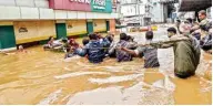  ?? PTI ?? People being rescued from a flood-affected region following heavy monsoon rainfall, in Kochi on Thursday