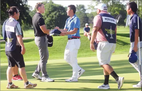  ?? Photo by Ernest A. Brown ?? Theo Humphrey, of Greenwich, Conn. and a student at Vanderbilt, left, congratula­tes Collin Morikawa after Morikawa wins the 56th Northeast Amateur at Wannamoise­tt Country Club Saturday afternoon. At far right is Doug Ghim of Texas.