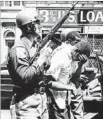  ?? AFP / Getty Images ?? POLICE make arrests on July 25, 1967, during riots that erupted in Detroit.
