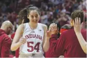  ?? AP PHOTO/DARRON CUMMINGS ?? Indiana's Mackenzie Holmes (54) is greeted by teammates Sunday after being taken out of an NCAA college basketball game during the second half against Purdue in Bloomingto­n, Ind.