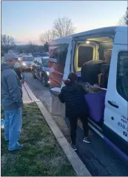  ??  ?? Cars line up to pick up meals through Do It Local Berks.