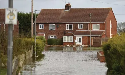  ?? Photograph: Oli Scarff/AFP via Getty Images ?? Flooding in East Cowick in March 2020. Unfortunat­ely as Britain becomes warmer it will also become wetter because of warming air trapping moisture in the atmosphere.