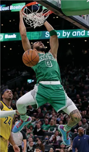  ?? STuART CAHiLL pHOTOs / HERALD sTAff ?? HANGING TOUGH: Celtics forward Jayson Tatum dunks the ball during their win over the Pacers at TD Garden on Friday night.