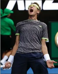  ?? The Associated Press ?? STUNNER DOWN UNDER: Uzbekistan’s Denis Istomin celebrates his win over Serbia’s Novak Djokovic during their second round match at the Australian Open tennis championsh­ips Thursday in Melbourne, Australia. It was Djokovic’s earliest loss at a Grand Slam...