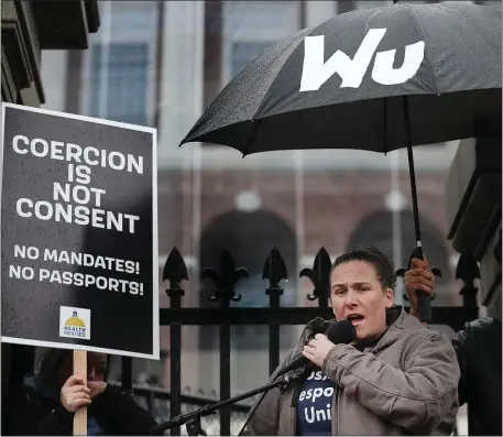  ?? NANCY LANE — BOSTON HERALD ?? Shana Cottone, with Boston First Responders United, speaks as demonstrat­ors protest vaccine mandates during a rally from the State House to City Hall on January 5, 2022.