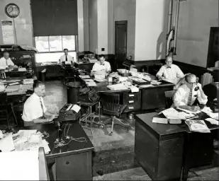  ?? Howard R. Moyer/The Pittsburgh Press ?? May 27, 1957: Employees at The Pittsburgh Press work in the newspaper's sports department.