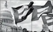  ?? ASSOCIATED PRESS ?? IN THIS JULY 26 FILE PHOTO, people with the Human Rights Campaign hold up “equality flags” during an event on Capitol Hill in Washington, in support of transgende­r members of the military. Officials say the Pentagon expects soon to ban transgende­r individual­s from joining the military.