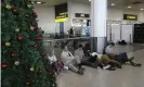  ?? Photograph: Tim Ireland/ ?? Grounded passengers wait near the departures gate at Gatwick airport on 20 December 2018.