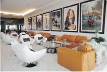  ??  ?? A lounge area decorated with photograph­s of celebritie­s is just one small area of this four-level, 38,000-square-foot mansion in Los Angeles.