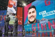  ?? Eric Gay / Associated Press ?? Former Giants player Justin Tuck, left, announces New York’s selection of UTEP's Will Hernandez as the team’s second-round selection in the NFL draft on Friday.