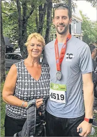  ?? CONTRIBUTE­D PHOTO ?? Cynthia Oliver of Burnt Point came to St. John’s Sunday to see her son, Trevor Harris, participat­e in the Tely 10 road race. He surprised her at the halfway point of the race by running up to her to give her a birthday card.