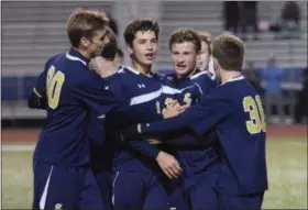  ?? AUSTIN HERTZOG — DIGITAL FIRST MEDIA ?? Spring-Ford players celebrate with Colin Trainor, left, and Brett Gulati, right, after the two connected for the Rams’ third goal against West Chester East.