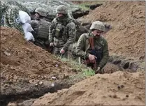  ?? GENYA SAVILOV – GETTY IMAGES ?? Ukrainian servicemen stand in a trench near their position near the town of Bakhmut, Donetsk region, on April 8amid the Russian invasion.