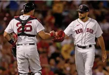  ?? MATT STONE / HERALD STAFF FILE ?? COMFORT LEVEL: Catcher Kevin Plawecki bumps fists with pitcher Nathan Eovaldi against the Tampa Bay Rays at Fenway Park on Sept. 8.
