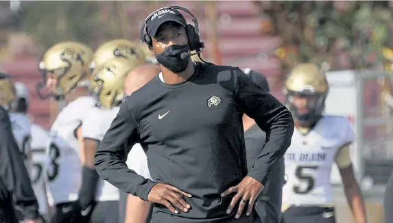 ?? Jeff Chiu, The Associated Press ?? First- year Colorado head coach Karl Dorrell, center, has been tasked with providing stability and a winning culture for a Buffs football program that sorely needs it.