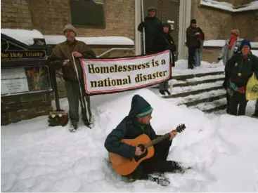  ?? MICHAEL STUPARYK/TORONTO STAR FILE PHOTO ?? A guitarist plays at a 2001 Toronto Disaster Relief Committee memorial service for people who died on the streets.