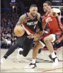  ?? Photo credit ?? Trail Blazers guard Damian Lillard drives to the basket on Rockets forward Jabari Smith Jr. during the second half Sunday.