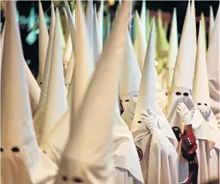  ?? Picture: AFP / FRANÇOIS-XAVIER MARIT ?? ANNUAL REMEMBRANC­E: Hooded penitents take part in a Holy Monday procession in Cordoba, Spain, as part of the Holy Week ahead of Easter.