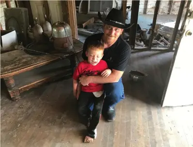  ?? Lauren McGaughy /The Dallas Morning News via AP ?? ■ Chris Ward poses with his son, 6-year-old Ryland, on Monday at the family home he and his brother are remodeling in La Vernia, Texas. Ward lost his wife and two daughters in the shooting at First Baptist Church of Sutherland Springs. Ryland, who was...