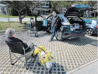  ?? JOHN RENNISON THE HAMILTON SPECTATOR ?? Sharon Chaplin sits in a chair as she visits with her son Chris, his wife Julie and granddaugh­ters Violet 11, and Aubrey, 12, in a parking lot on Upper Kenilworth, across from her apartment building.