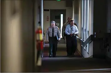  ?? PHOTOS BY JOHN DONEGAN / THE CALIFORNIA­N ?? Kern County Sheriff Donny Youngblood walks to a press conference Thursday afternoon regarding Kern County Supervisor Zack Scrivner.