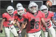  ?? Jeremy Stewart ?? Cedartown’s Jayden Weems (56) throws the ball up as he celebrates with his teammates after blocking a punt and returning it for a touchdown during Friday’s game.