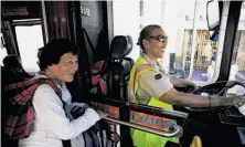  ?? Photos by Lea Suzuki / The Chronicle ?? Transit operator Linda Wilson-Allen chats with a passenger while driving the 45-Union Muni bus in San Francisco.