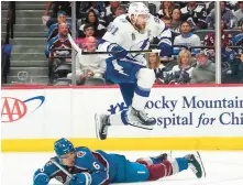  ?? JOHN LOCHER/AP ?? Lightning center Steven Stamkos (91) jumps over Avs defenseman Erik Johnson during Game 1. Game 2 was not finished in time for this edition.