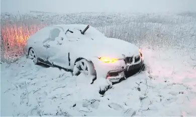  ??  ?? Nowhere to go...a car gets stuck after last month’s snowfall in Derbyshire’s Peak District caused chaos