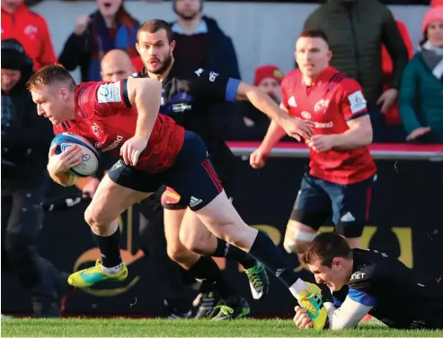  ??  ?? Close encounter: Rory Scannell gets away from a foot tackle to score a try for Munster