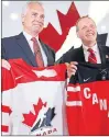  ?? CP PHOTO ?? Tom Renney, left, and Hockey Canada chairman of the board Jim Hornell pose with jerseys in this 2014 file photo when Renney was introduced as the new president and CEO of Hockey Canada. Hornell, it should be noted, is a native of Grand Falls-windsor...