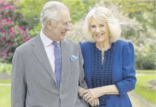  ?? ?? King Charles III and Queen Camilla, taken by portrait photograph­er Millie Pilkington, in Buckingham Palace Gardens. The picture has been released to mark the first anniversar­y of the crowning of the King and Queen on May 6