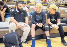  ?? MARLA BROSE/JOURNAL ?? First-year Cleveland head coach Even Copeland, left, talks to wrestlers Jack Luttrell, center, and Ty Medford before a recent meet.