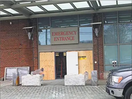  ?? Cassandra Day / Hearst Connecticu­t Media ?? Crews work to repair the damage done to the Middlesex Hospital emergency room on Crescent Street in Middletown Monday morning. Steven B. Ellam intentiona­lly drove his car into the building Thursday, police said.