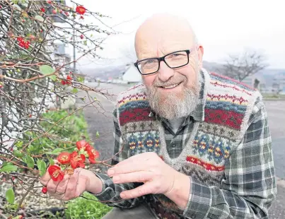  ??  ?? SURPRISE: Jan Overmeer and his colourful quince shrub which can be seen from Lochcarron’s main street