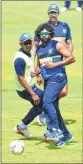  ??  ?? Sri Lanka's coach Nic Pothas (R) plays football with Lasith Malinga and Danushka Gunathilak­a (L) during a practice session at the Pallekele Stadium on Wednesday