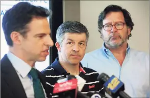  ?? Ned Gerard / Hearst Connecticu­t Media file photo ?? Ian Hockley, center, father of Sandy Hook Elementary School student Dylan Hockley, and Bill Sherlach, right, husband of Sandy Hook Elementary School psychologi­st Mary Sherlach, look on as attorney Josh Koskoff speaks at a news conference in Bridgeport on March 14, 2019. Nine families are suing gunmaker Remington for unlawful marketing.