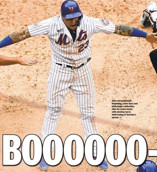  ?? AP ?? After uncomforta­ble beginning, Javier Baez and Mets begin celebratio­n after he comes home with winning run in ninth inning of Tuesday’s opener.