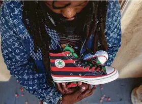  ?? Jason Armond / Tribune News Service ?? Tremaine Emory displays a pair of sneakers he designed that are inspired by the Pan-African flag.